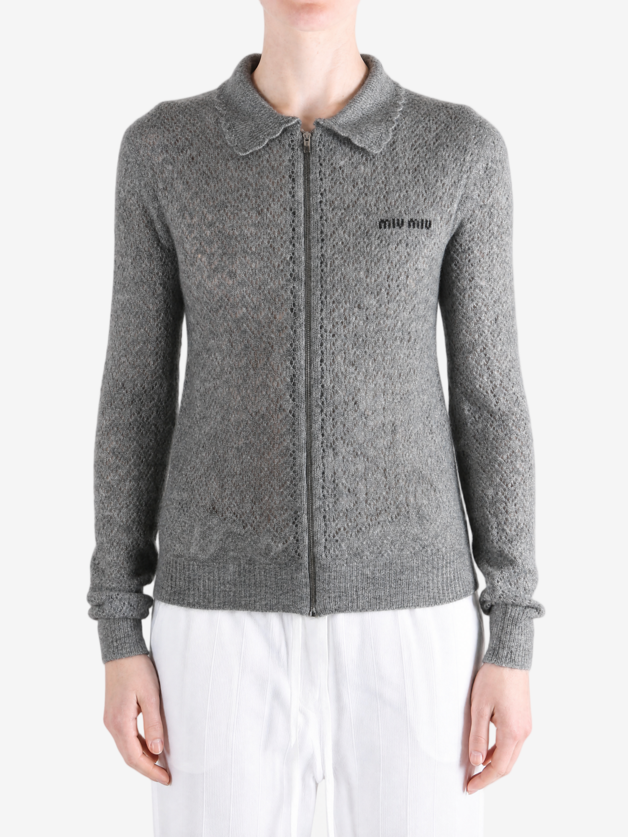 Grey knitwear worn by a person, showing the knitwear fit