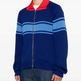 Blue knitwear worn by a person, showing the knitwear fit