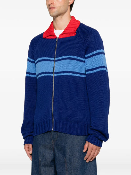 Blue knitwear worn by a person, showing the knitwear fit
