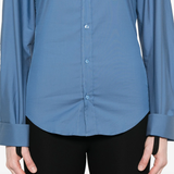 Close up of blue shirt, showing texture of the cotton fabric