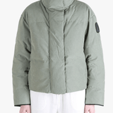 Green jacket worn by a person, showing the jacket fit