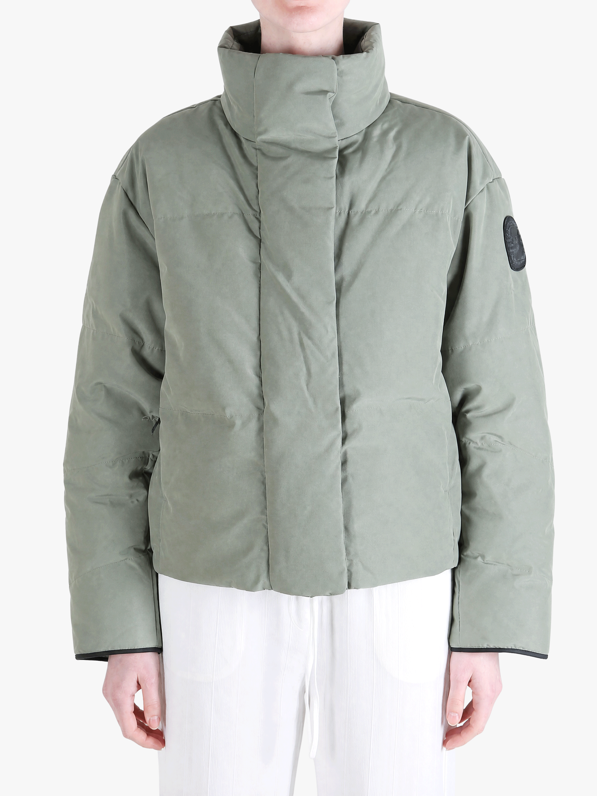 Green jacket worn by a person, showing the jacket fit