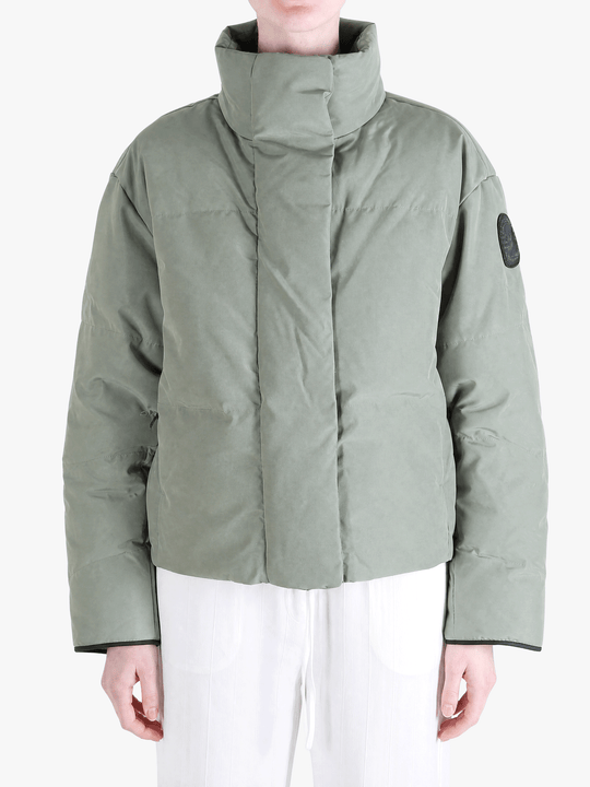 Green jacket worn by a person, showing the jacket fit