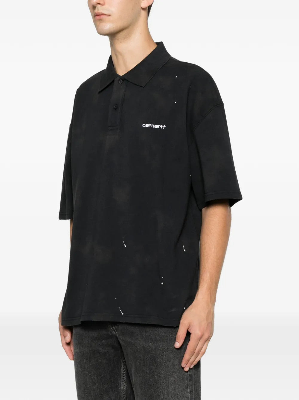 Black shirt worn by a person, showing the shirt fit