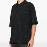 Black shirt worn by a person, showing the shirt fit