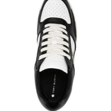 Close up of black sneakers, showing texture of the leather fabric