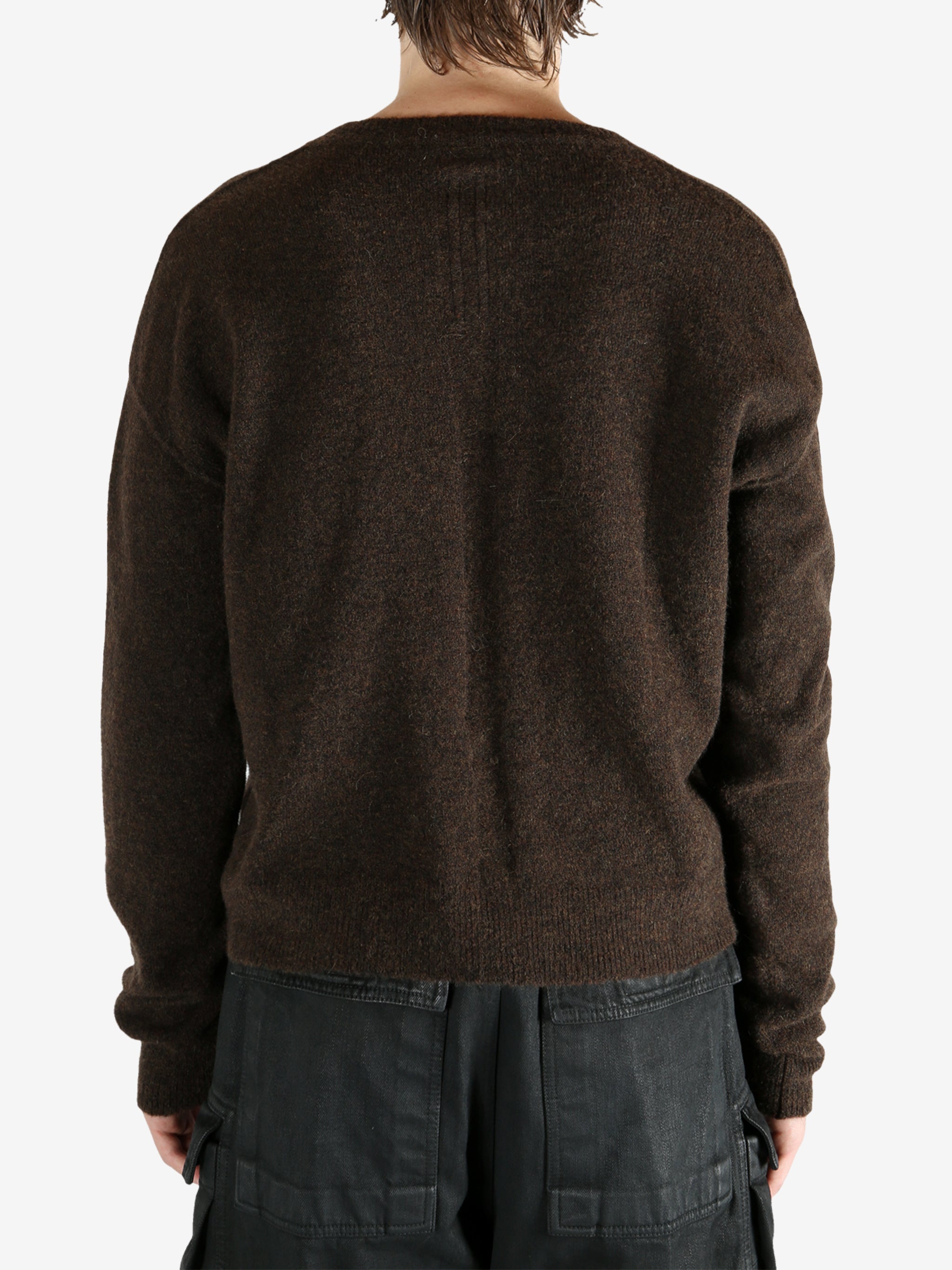 Brown knitwear worn by a person, showing the knitwear's fit