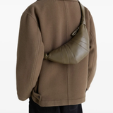 Green bag worn by a person, showing the bag's fit