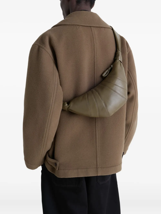 Green bag worn by a person, showing the bag's fit