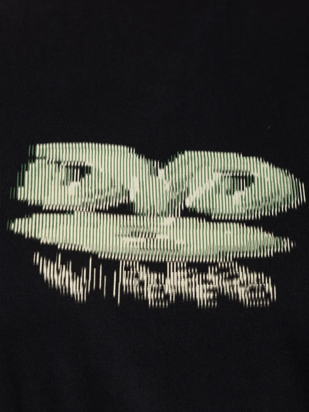 Close up of the black t-shirt, showing texture of the cotton fabric