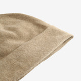 Close up of tan hats, showing texture of the cashmere fabric