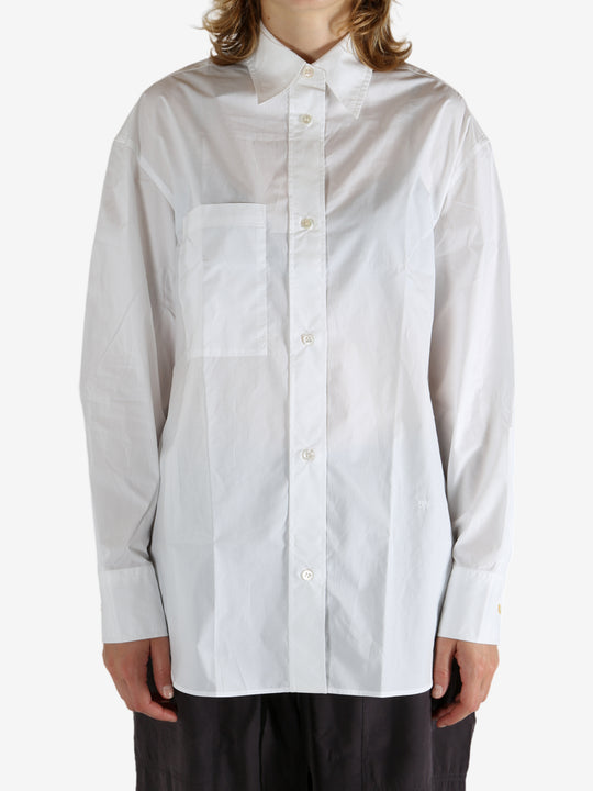 White shirt worn by a person, showing the shirt's fit