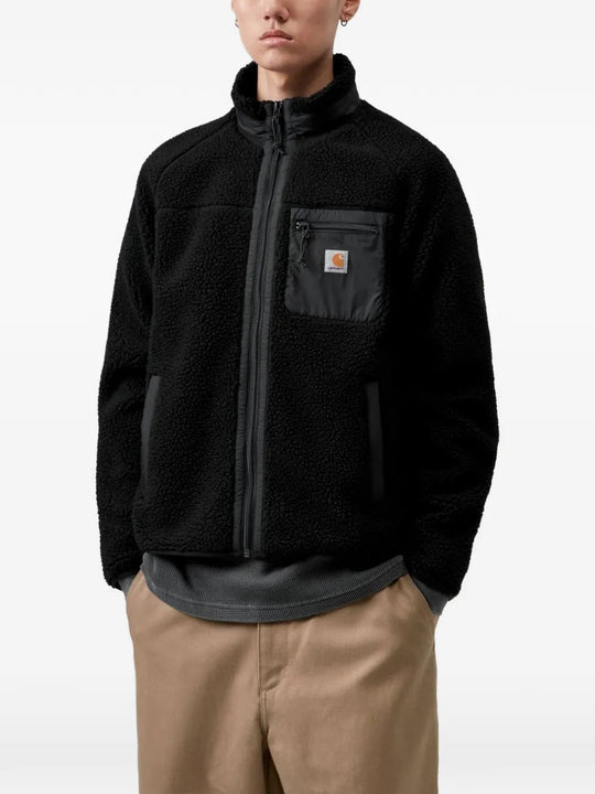 Black jacket worn by a person, showing the jacket fit