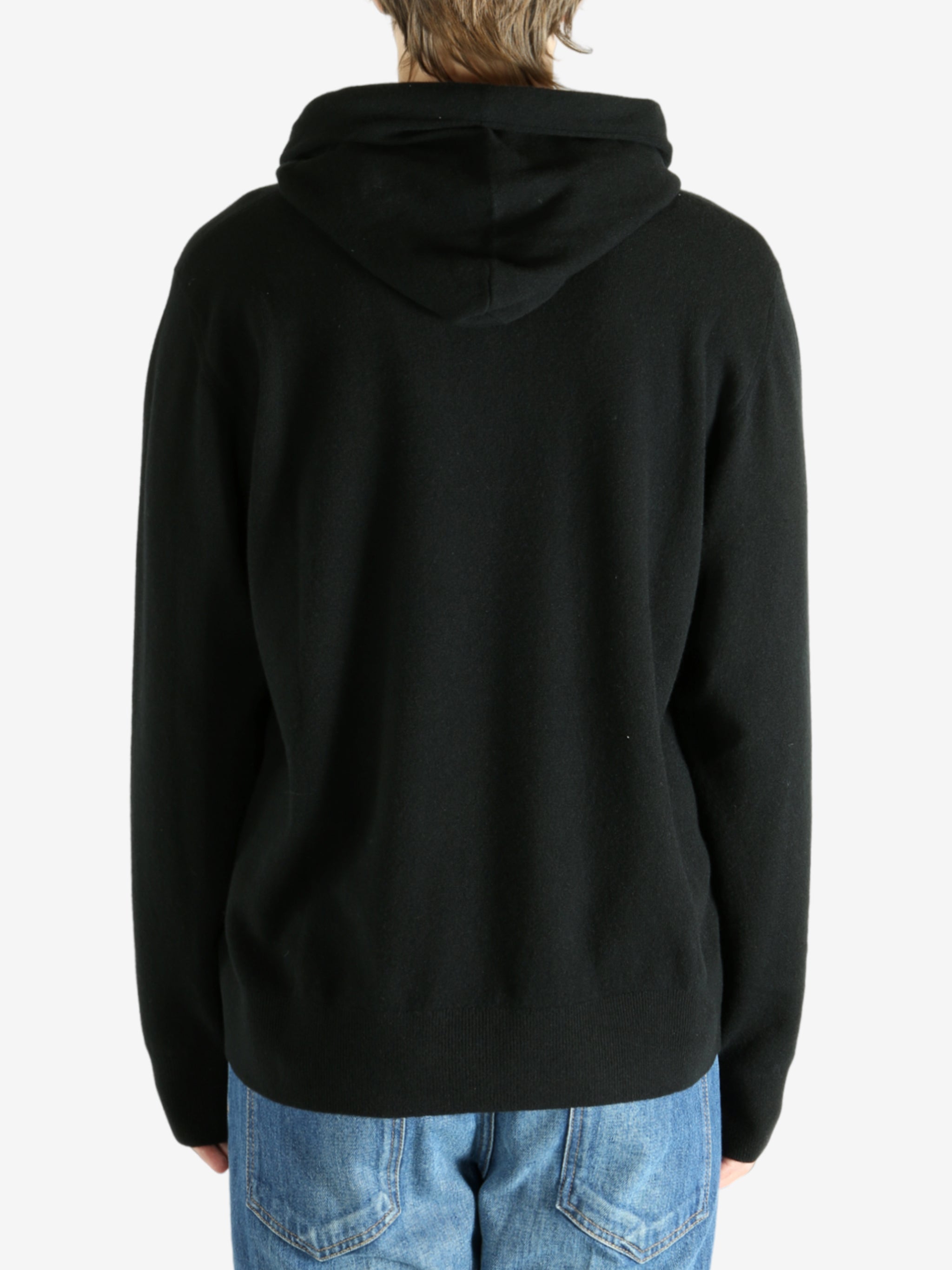 Black hoodie worn by a person, showing the hoodie's fit