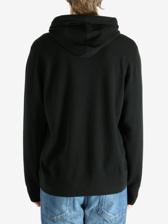 Black hoodie worn by a person, showing the hoodie's fit