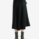 Black skirts worn by a person, showing the skirts fit