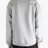 Grey sweater worn by a person, showing the sweater's fit