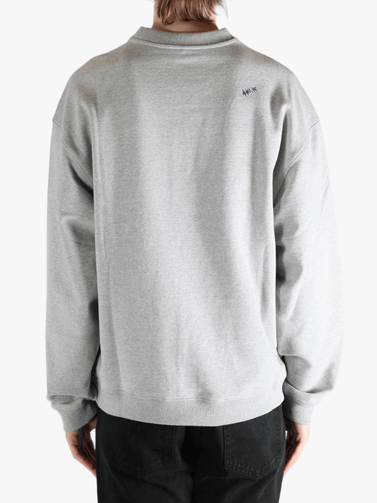 Grey sweater worn by a person, showing the sweater's fit