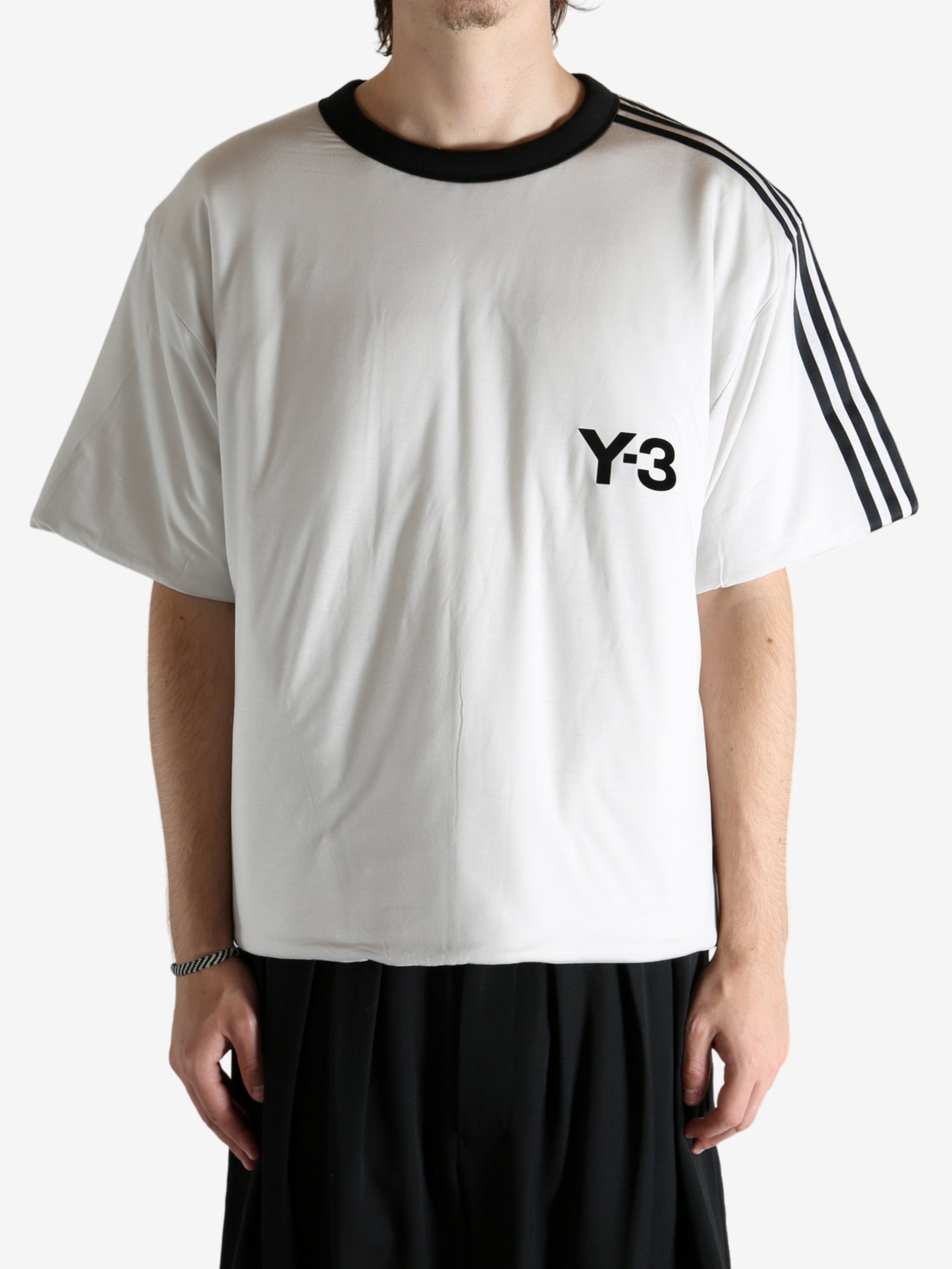 White t-shirt worn by a person, showing the shirt's fit