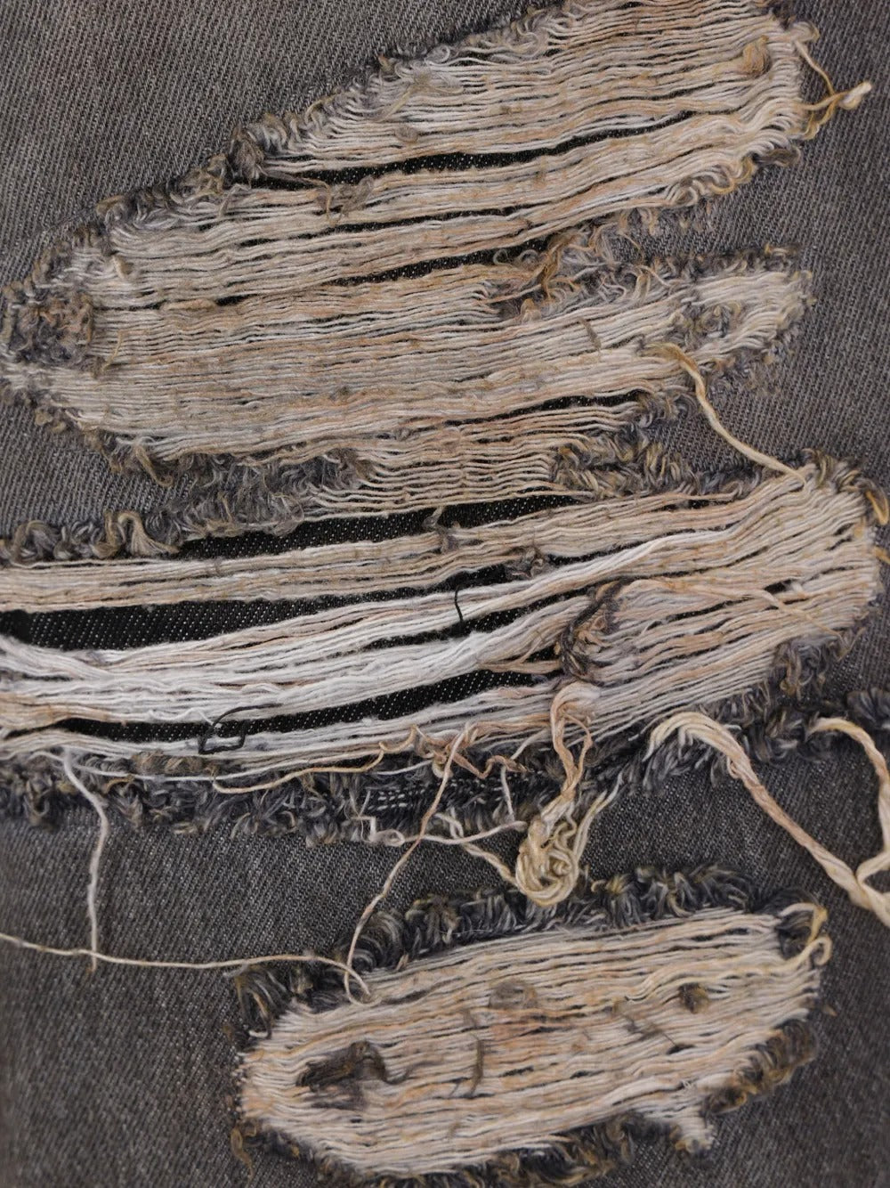 Close up of the balck jeans, showing texture of the cotton fabric