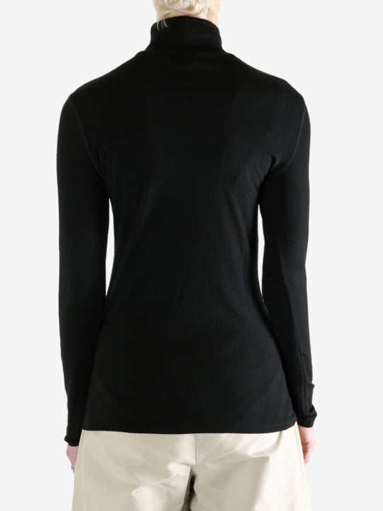 Black t-shirt worn by a person, showing the shirt's fit