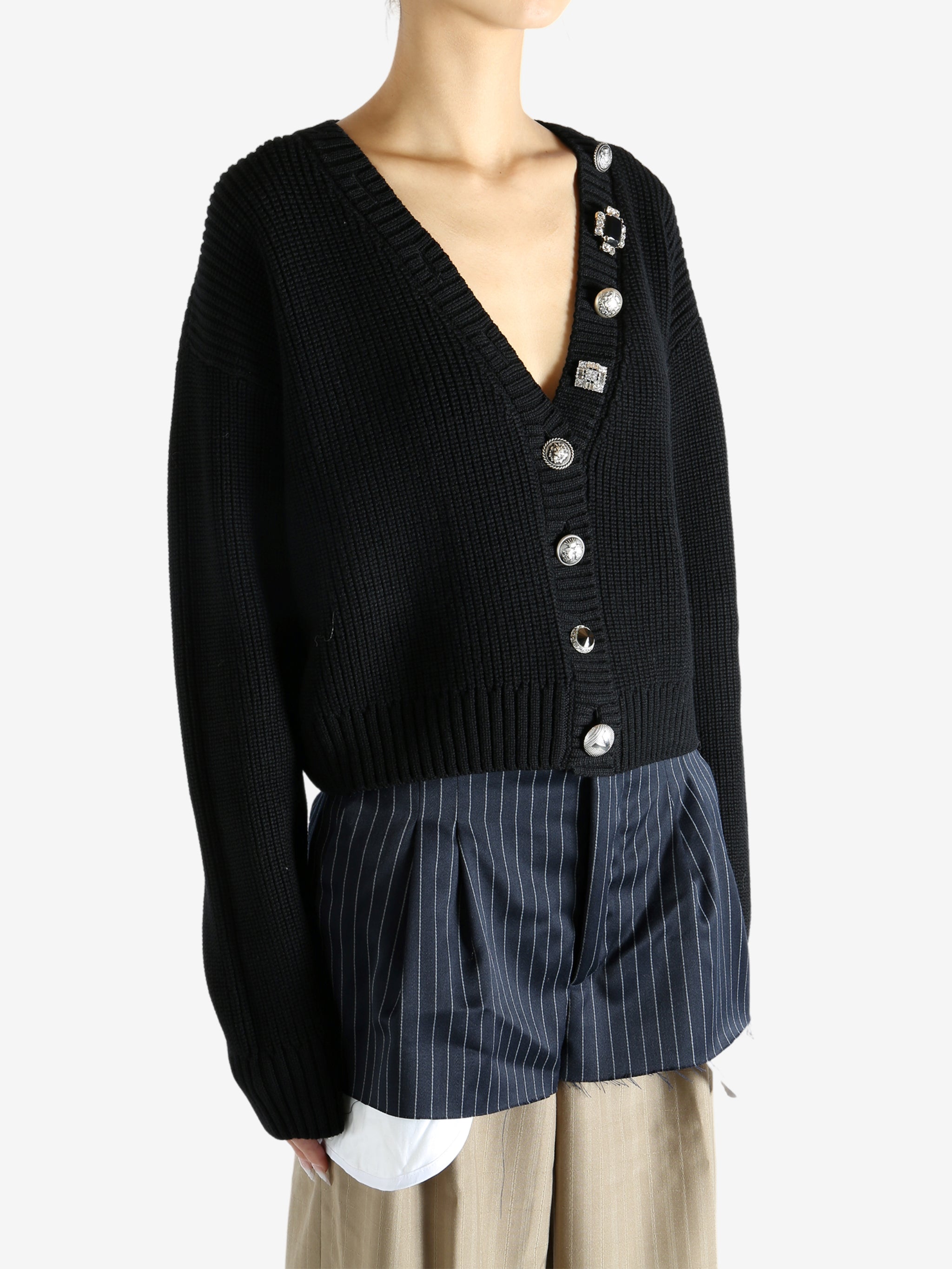Black cardigan worn by a person, showing the cardigan’s fit