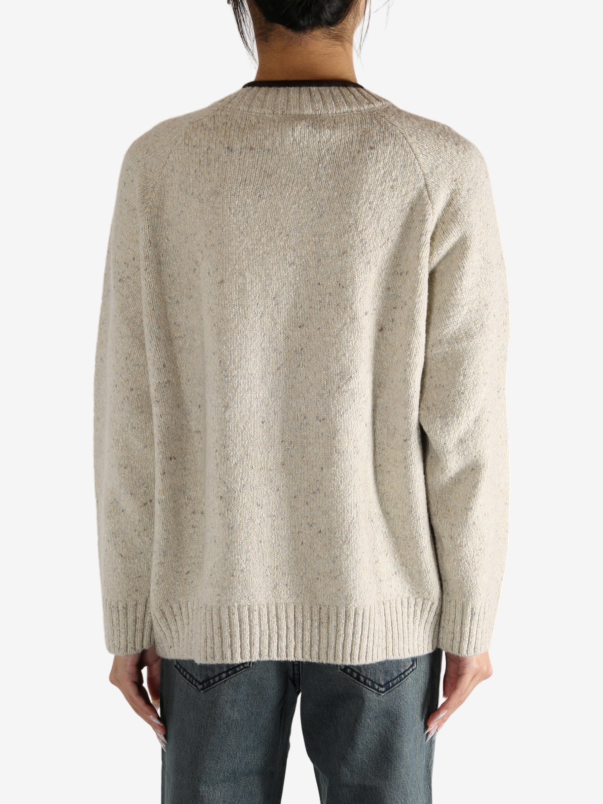 White knitwear worn by a person,showing the knitwear's fit