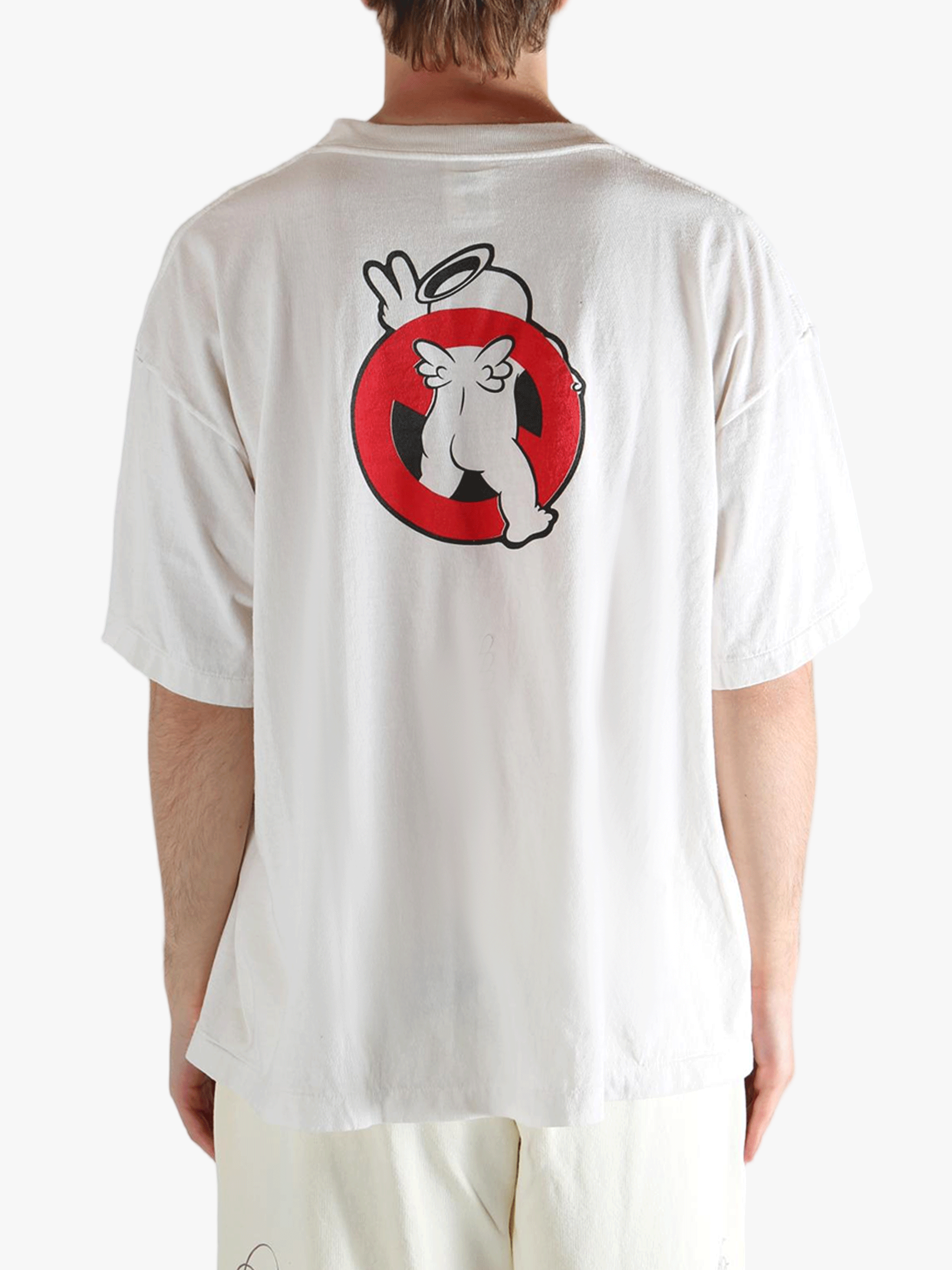 White t-shirt worn by a person, showing the shirt's fit