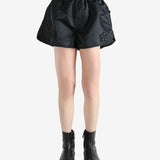 Black shorts worn by a person, showing the short's fit