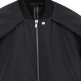 Close up of black jackets and coats, showing texture of the fabric