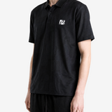 Black shirt worn by a person, showing the shirt fit