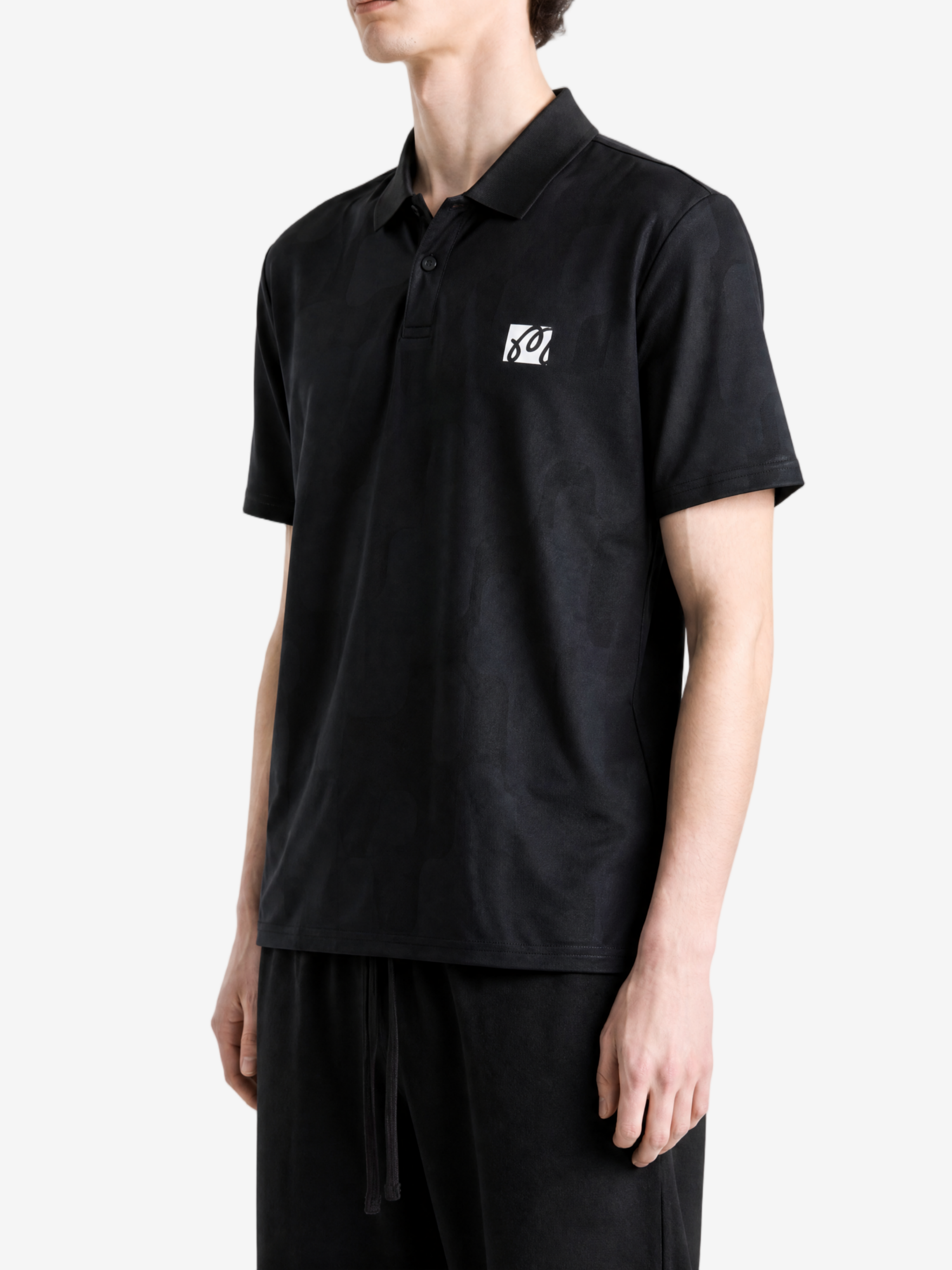 Black shirt worn by a person, showing the shirt fit