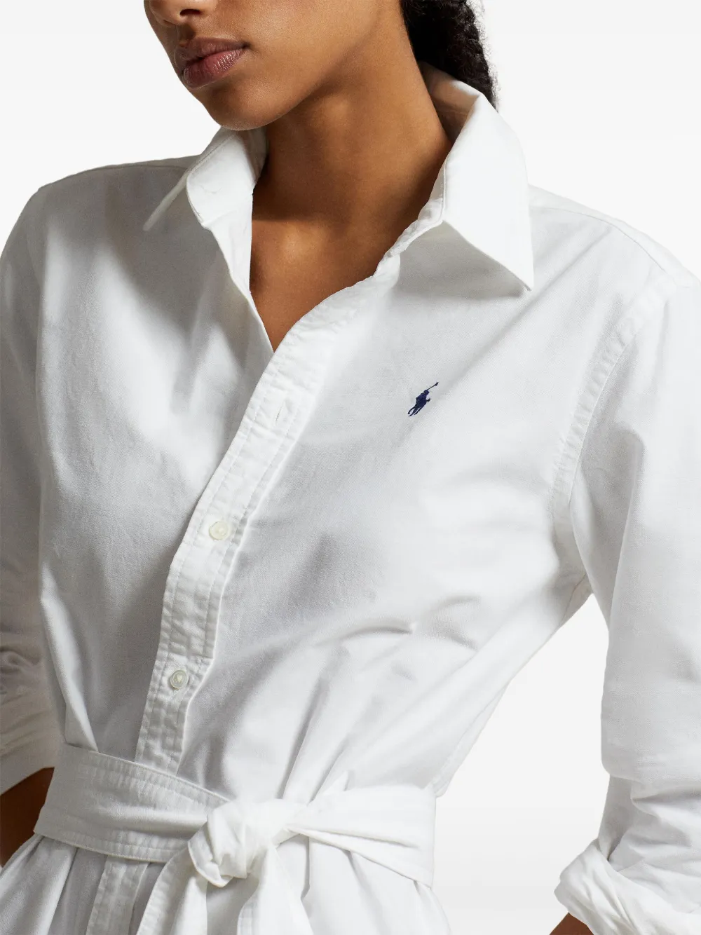 Close up of white shirtdress, showing texture of the cotton fabric