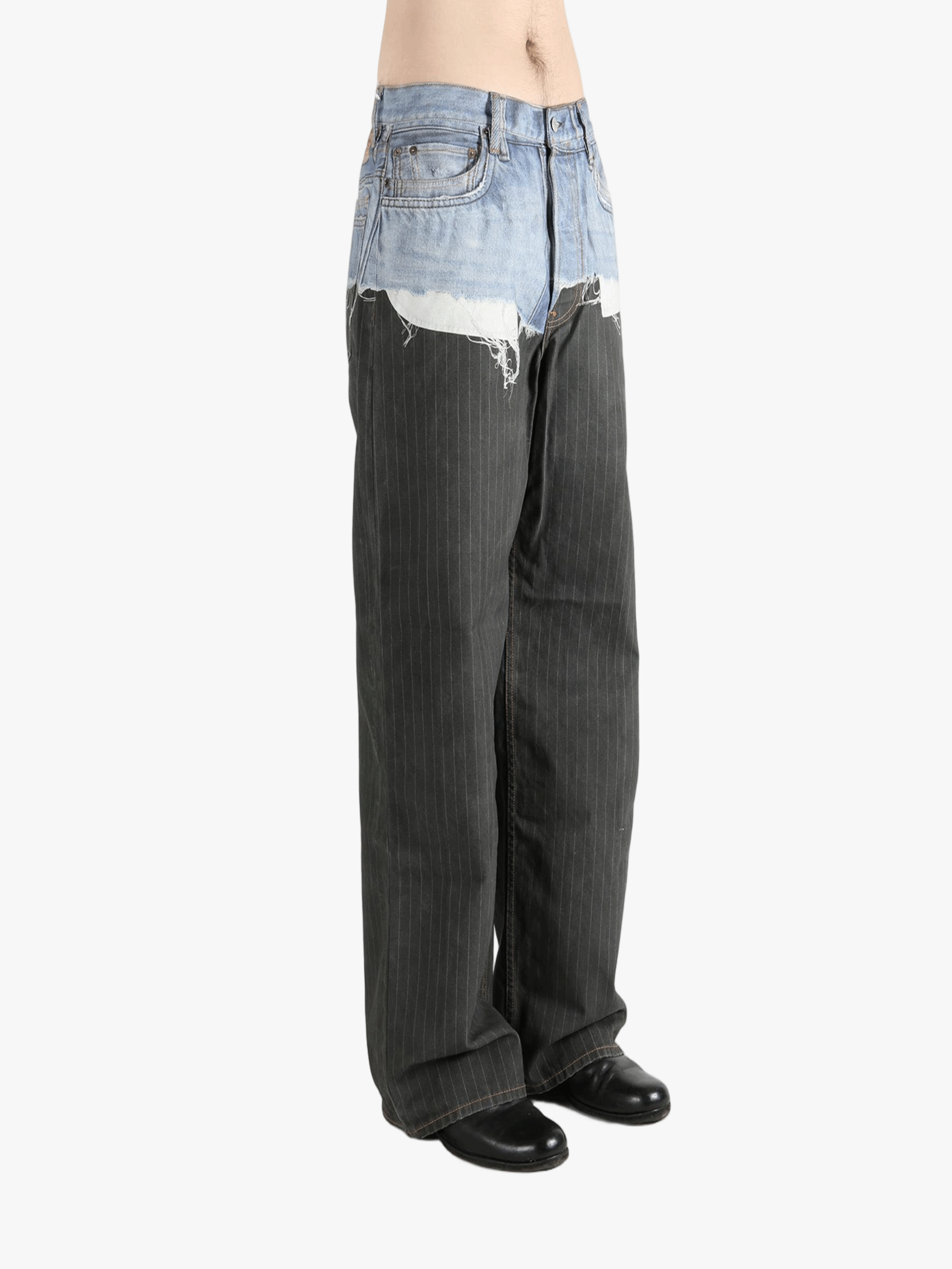 Black jeans worn by a person, showing the jeans fit