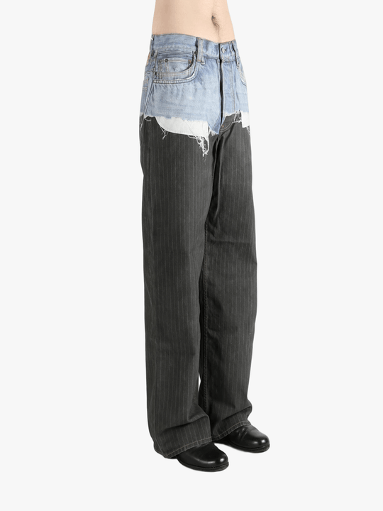 Black jeans worn by a person, showing the jeans fit