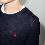 Close up of navy pullover, showing texture of the cotton fabric