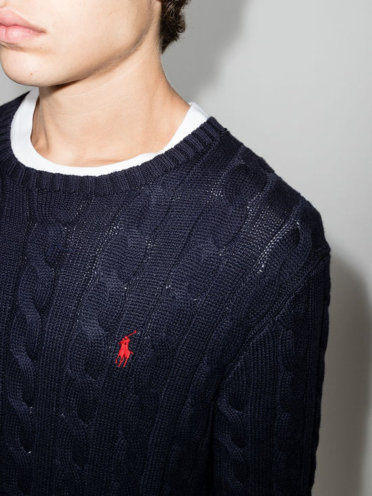 Close up of navy pullover, showing texture of the cotton fabric