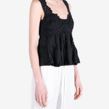Black top worn by a person, showing the top fit