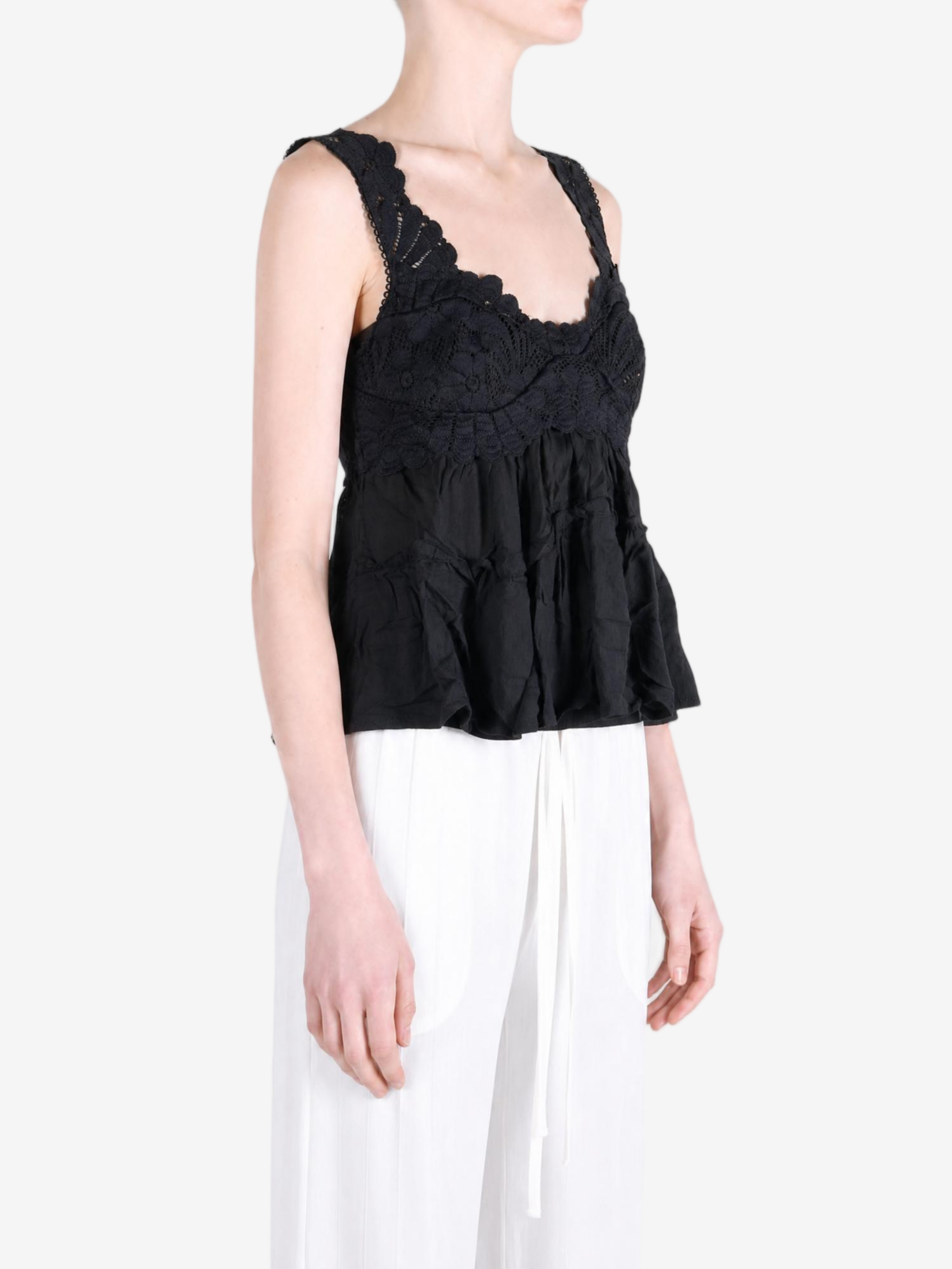 Black top worn by a person, showing the top fit