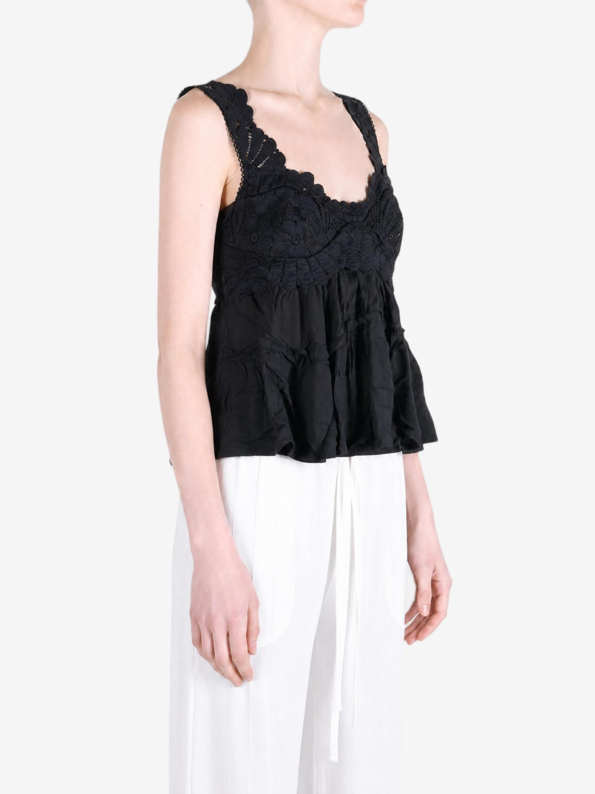 Black top worn by a person, showing the top fit