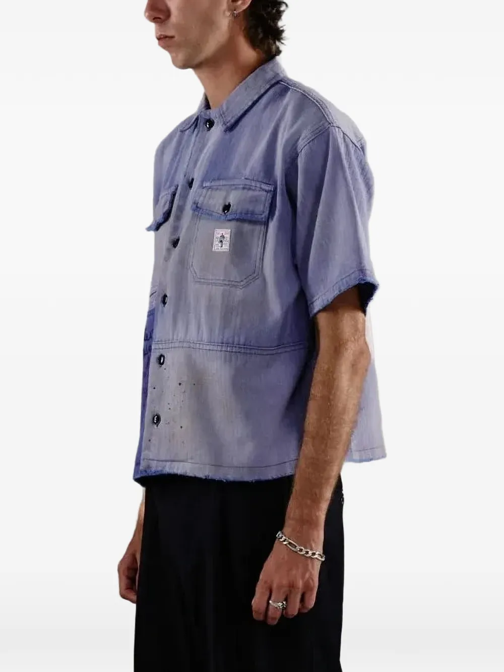 Blue shirt worn by a person, showing the shirt fit