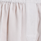 Close up of white short, showing texture of the lyocell fabric.