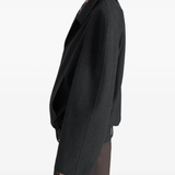 black jacket worn by a person, showing the jacket fit