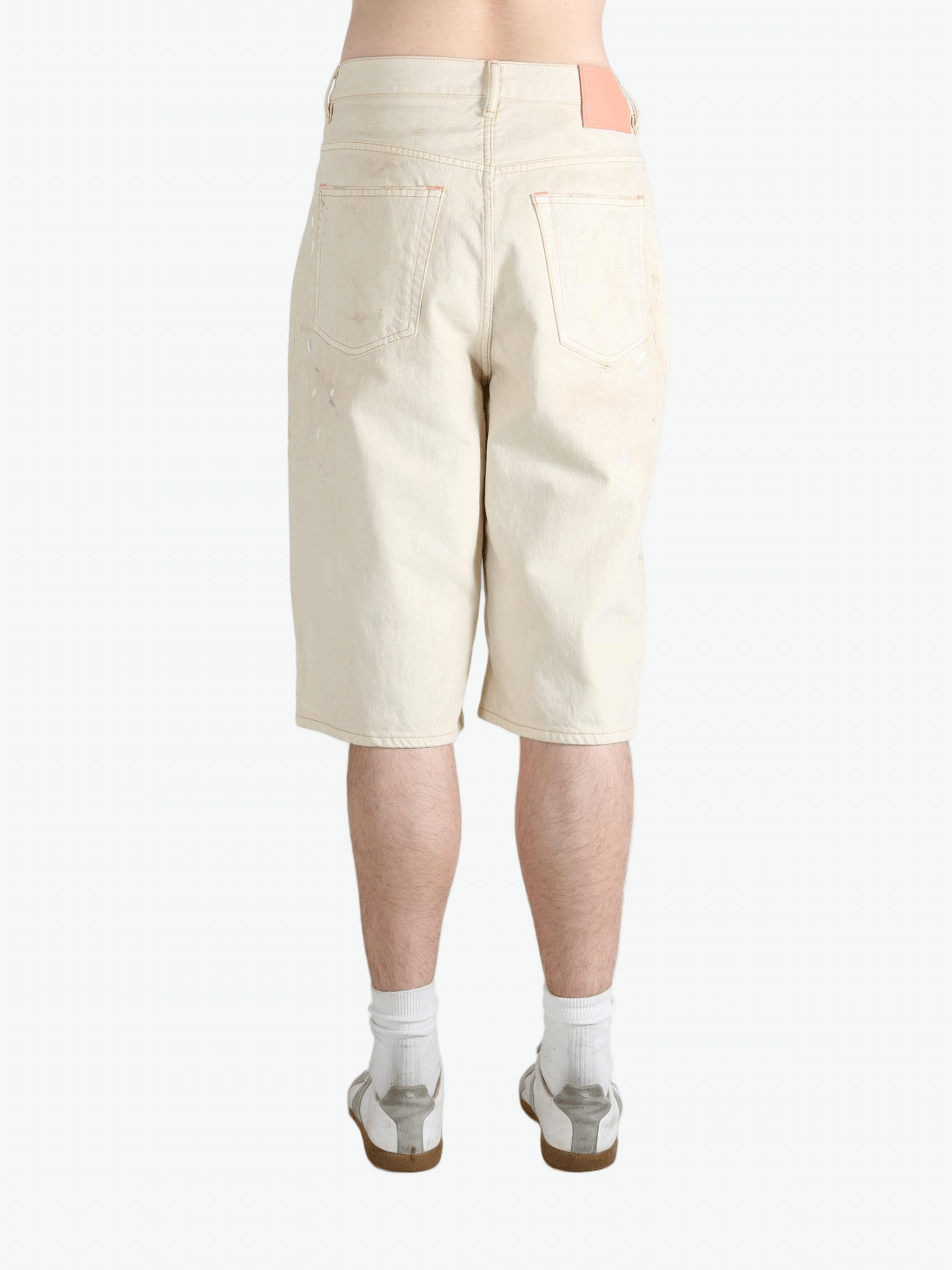 White shorts worn by a person, showing the shorts fit