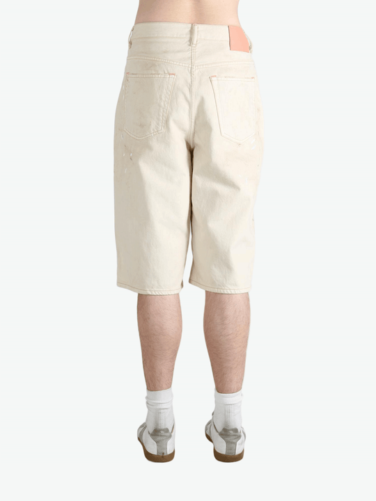 White shorts worn by a person, showing the shorts fit