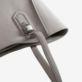 Close up of brown bag, showing texture of the leather fabric
