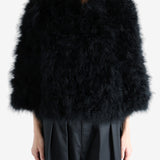 Black coat worn by a person, showing the coat's fit