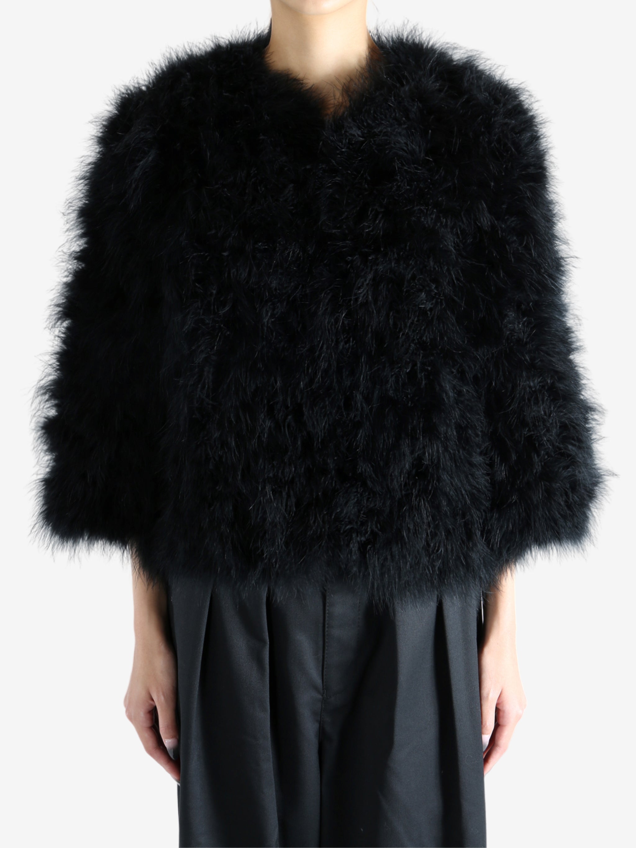 Black coat worn by a person, showing the coat's fit