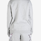 Grey knitwear worn by a person, showing the knitwear's fit