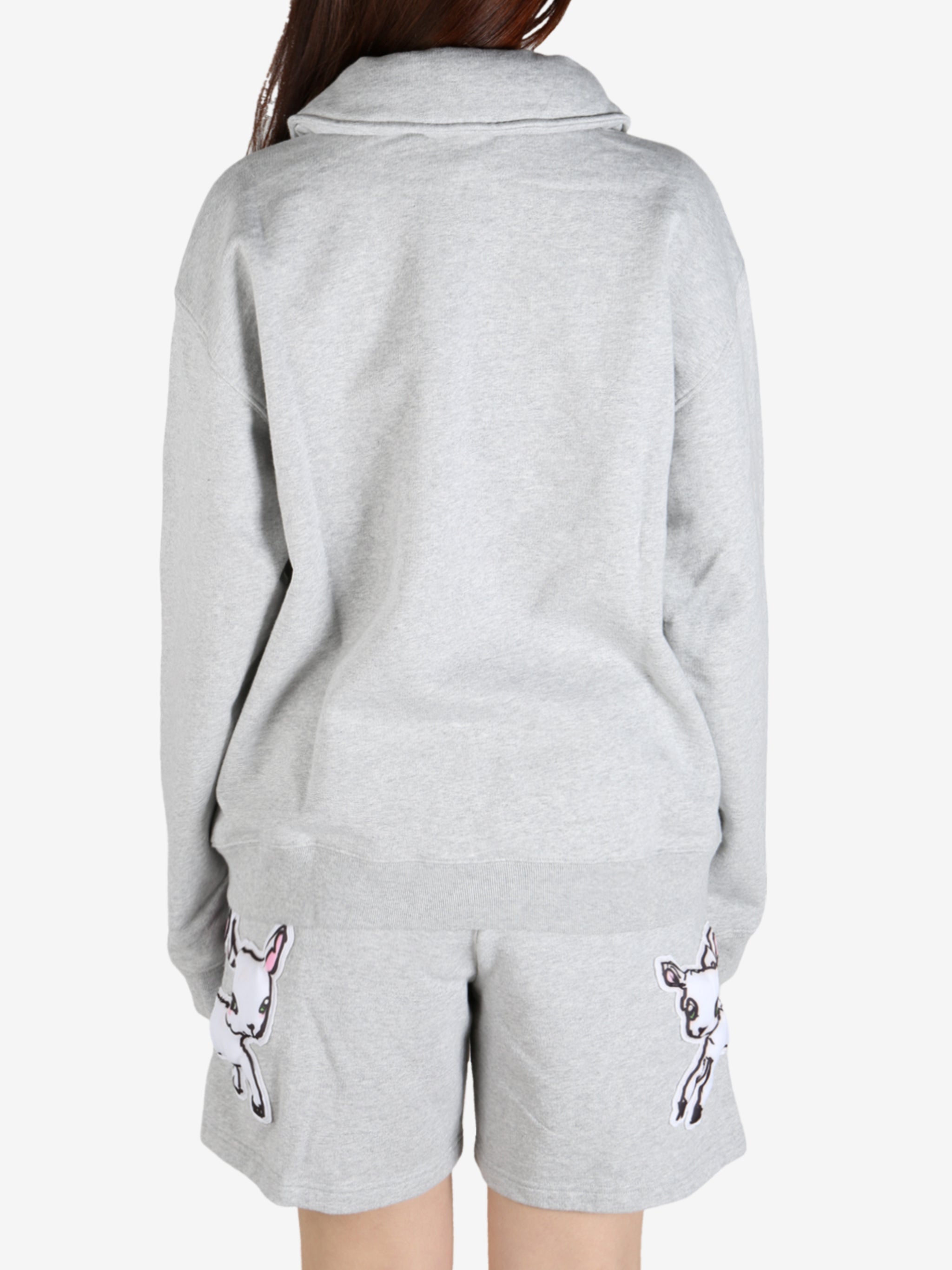 Grey knitwear worn by a person, showing the knitwear's fit